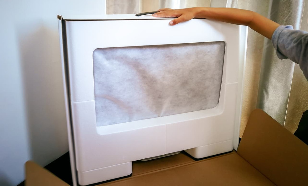 Flat-screen TV being secured with foam padding inside a specialized moving box for safe electronics transport