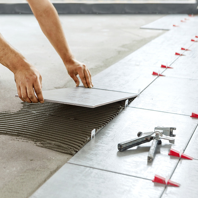 Professional tile installation on a floor with spacers for clean alignment and lasting results