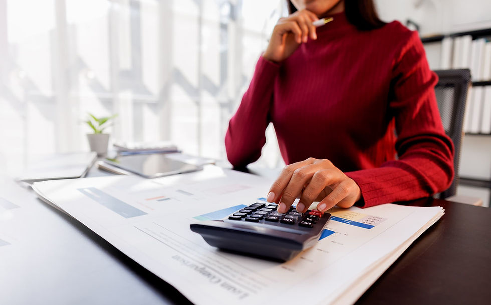 Woman using a calculator to estimate the cost of moving out of Colorado.