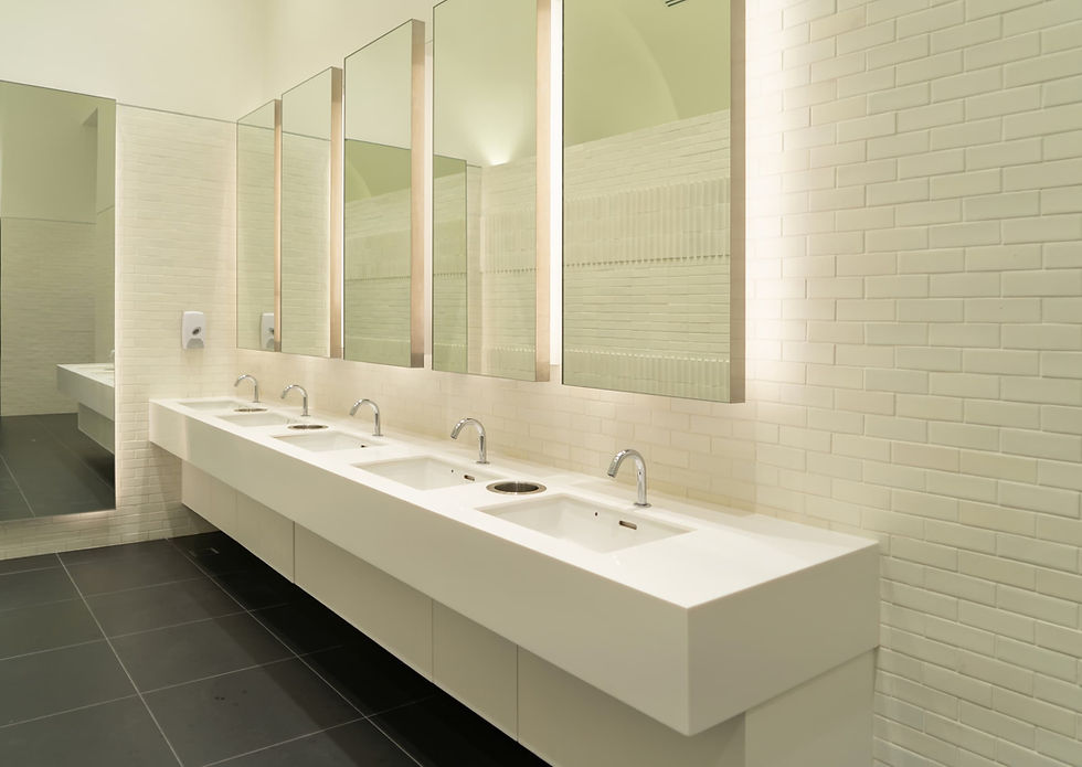 Bathroom mirrors with backlighting installed on a wall covered in small subway tile. The numerous grout lines break up the light, making the outline uneven and diminishing the floating effect.