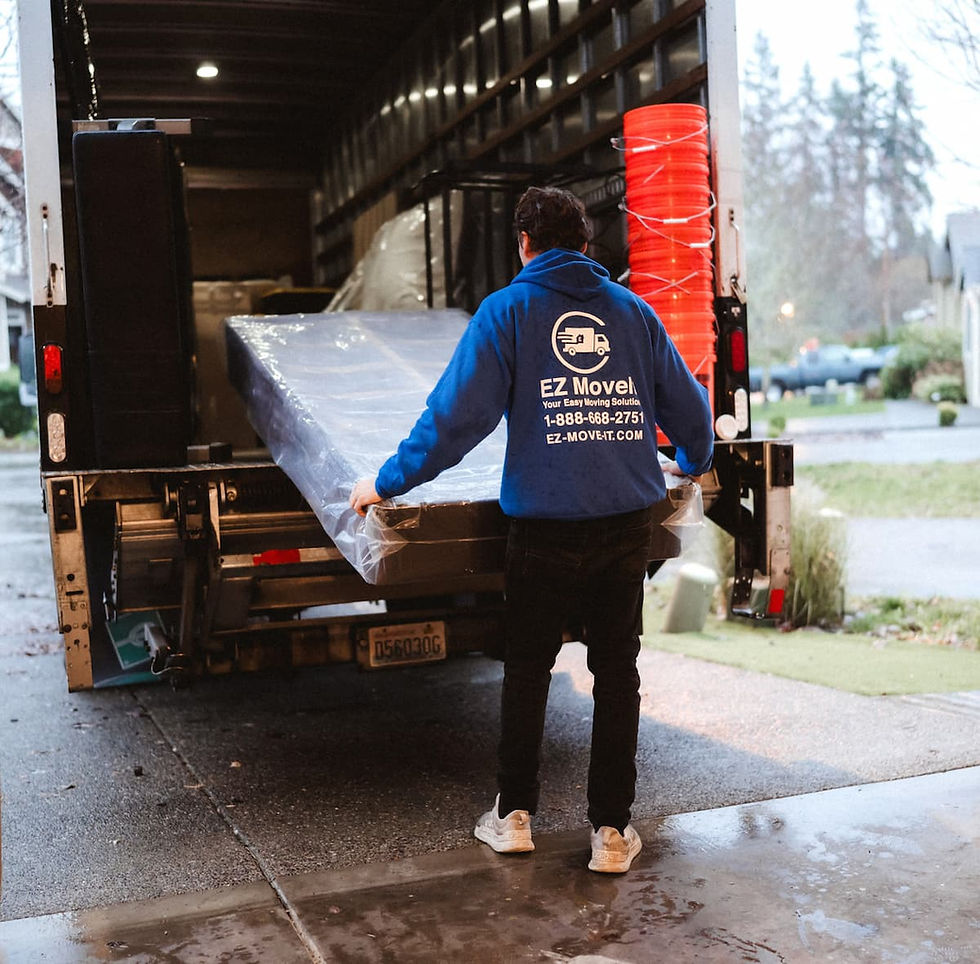 An EZ Movers professional carefully loading items into a moving truck for a seamless long-distance relocation.