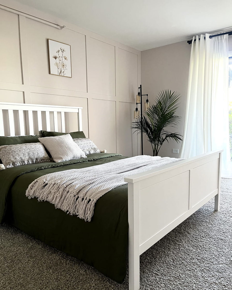 Finished bedroom featuring custom decorative drywall paneling.