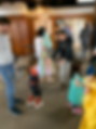 Kids dance in costumes as parents look on