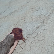 Girl Lying on Dry Ground