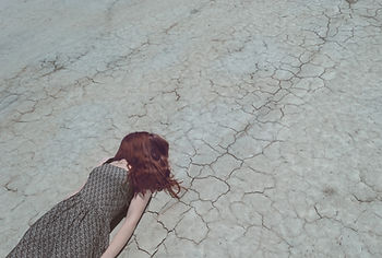  A woman laying down with her red hair covering her face