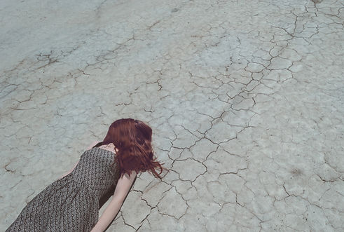 Girl Lying on Dry Ground