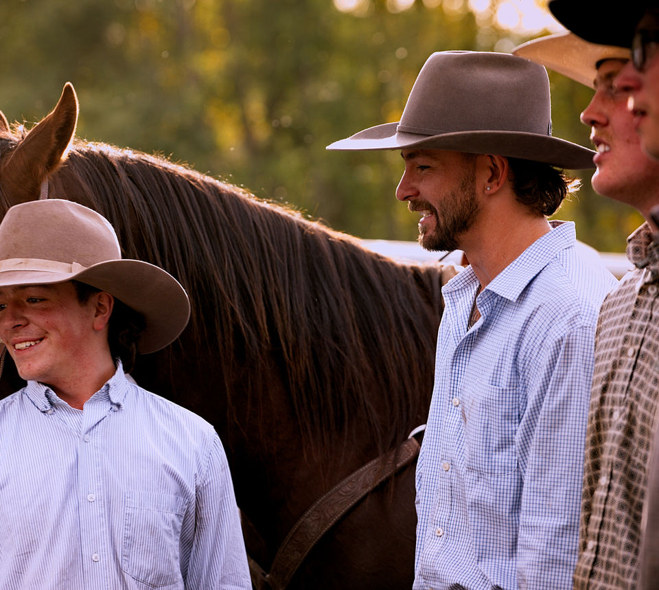 Cole, Rob, Bryer, and other cowboys smiling at the Beaver meadow Ranch Rodeo in October 2025