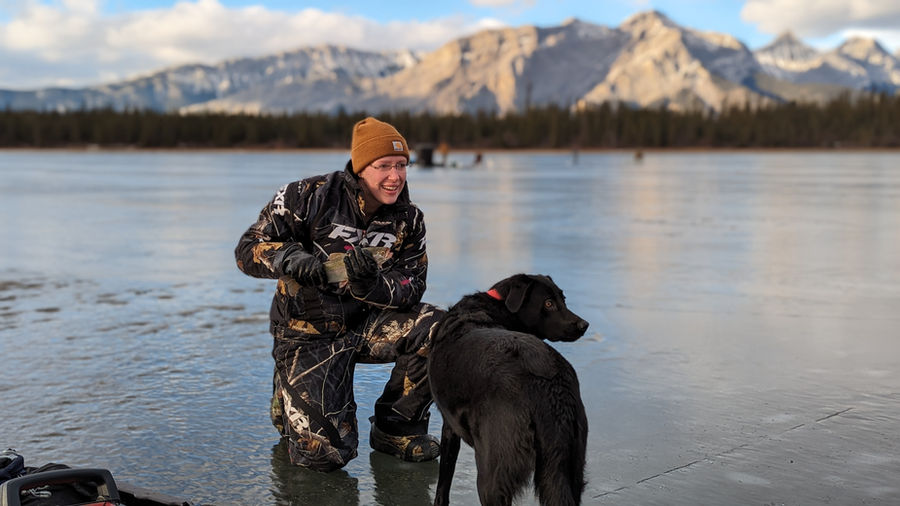 Ice fishing on a frozen lake in the rockies