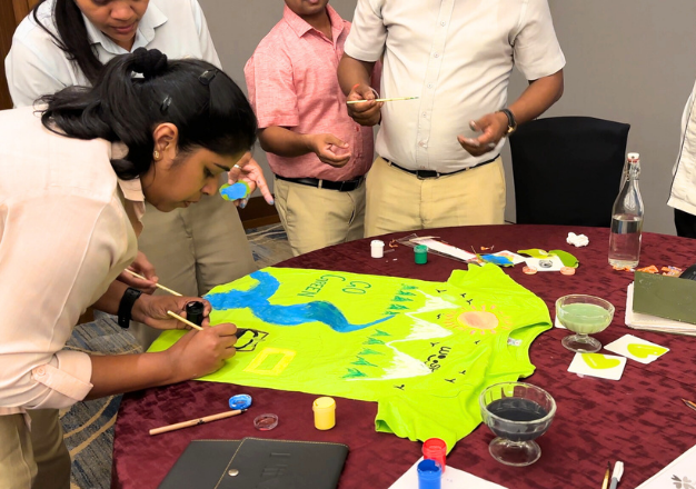 Employees painting or doing a craft activity together.