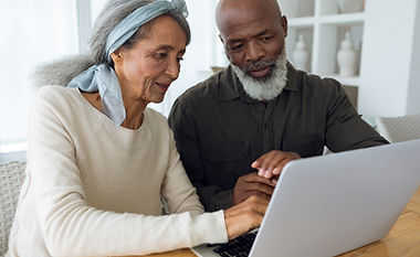 couple-using-white-laptop-table.jpg