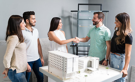 business-partners-shaking-hands-with-engineer-by-architectural-model-meeting.jpg