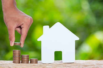 world-habitat-day-close-up-picture-pile-coins-model-house.jpg