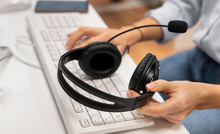 woman-working-call-center-holding-pair-headphones.jpg