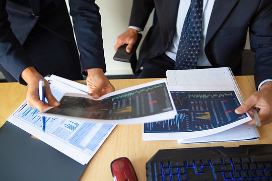 investor-trader-discussing-statistic-data-holding-papers-with-financial-charts-pen-cropped