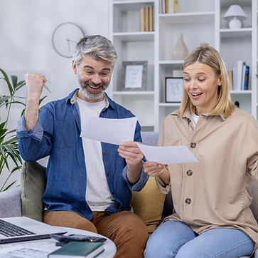 mature-couple-expresses-joy-while-looking-document-their-living-room-conveying-excitement_
