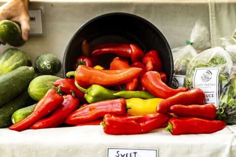 Cucumbers and peppers at a vendor stall.