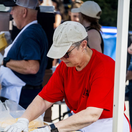 Vendor preparing breakfast burritos.