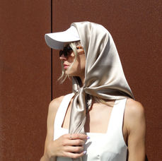 Beautiful and elegant woman with a silk scarf on head, vintage old money