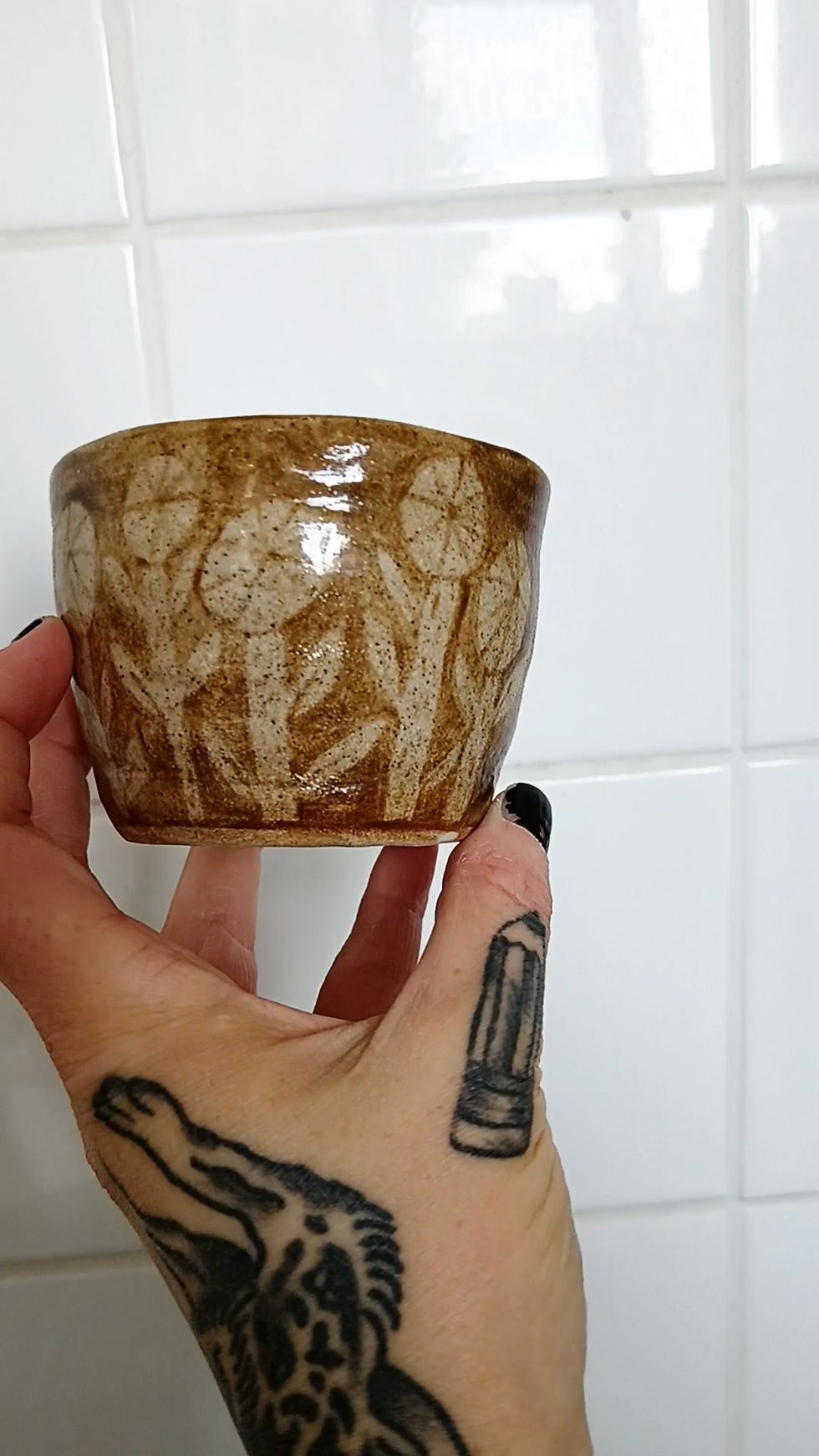 Thumbnail: hand painted underglaze flowers covering half of the ceramic cup