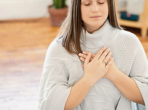 Close up photo of a woman meditating wit