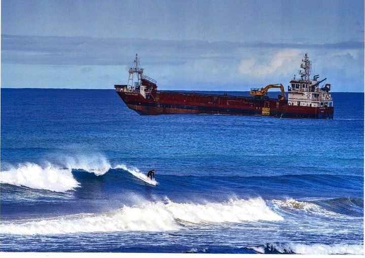 Boat and surfer