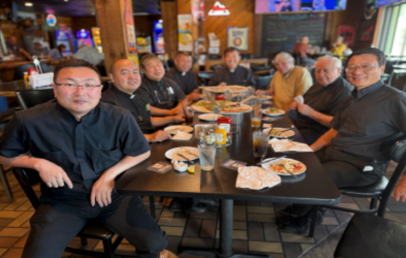 Shared meal and joyful fellowship among priests.