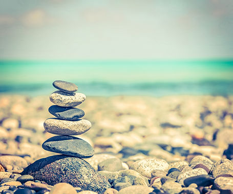 Vintage retro hipster style travel image of Zen meditation background -  balanced stones s