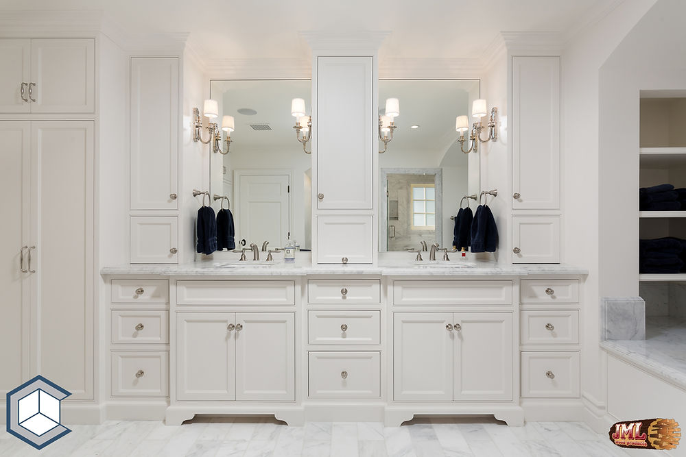 All white bathroom with his and hers sinks featuring all white cabinets and individual mirrors.