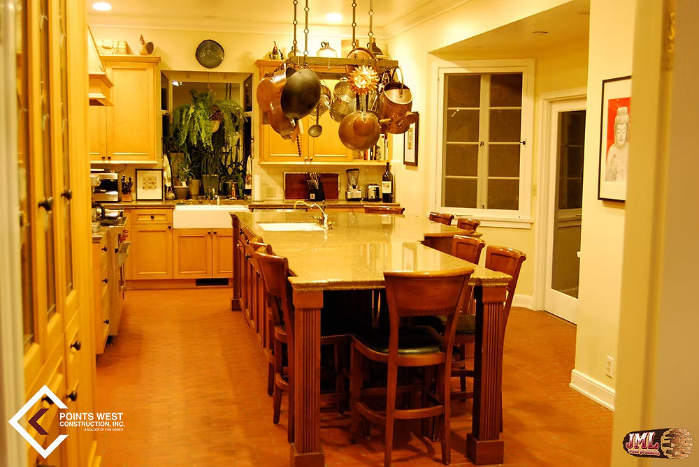 Traditional, contemporary style kitchen with hanging pot rack and dining table island.