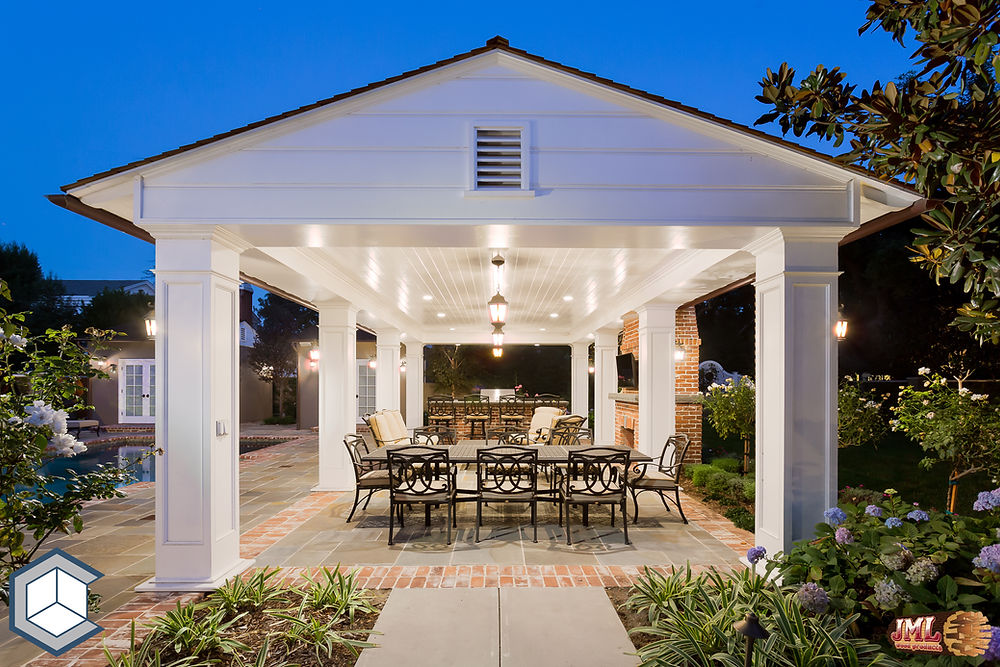 Covered (cabana) outdoor dining and living area at night.