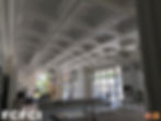 Kitchen area under construction with coffered ceiling and modern lights.