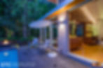 Master bedroom and out door pool area highlighting the home's open concept at night.
