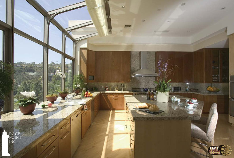 Luxury kitchen with windows that curve into the roof space, looking out at the mountains of LA.
