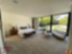 Master bedroom with sliding floor to ceiling windows leading to the backyard.