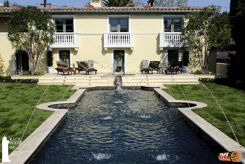 The pool's lounge patio, and the pool itself highlighting the water fountain features.