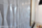 Grey blue tile ways in triangular and rectangular shapes up close.