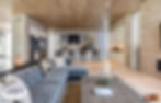 Living room view of modern kitchen, wood ceilings and stone walls.