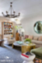 Living room area highlighting the home's organic shapes styled with a simple iron chandelier.