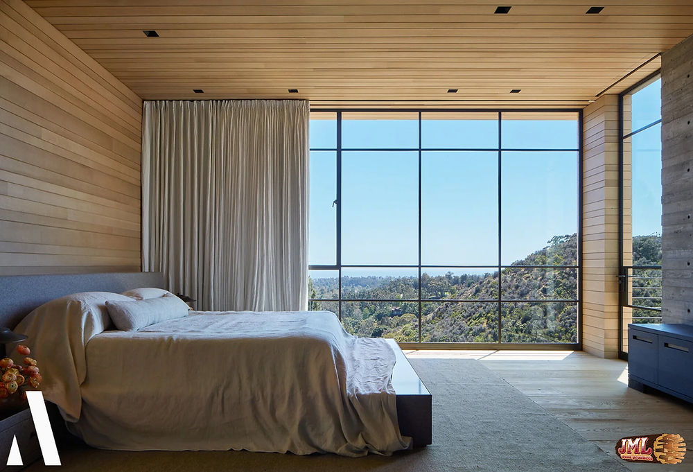 Master bedroom with natural wood ceilings and walls accompanied with floor to ceiling windows.