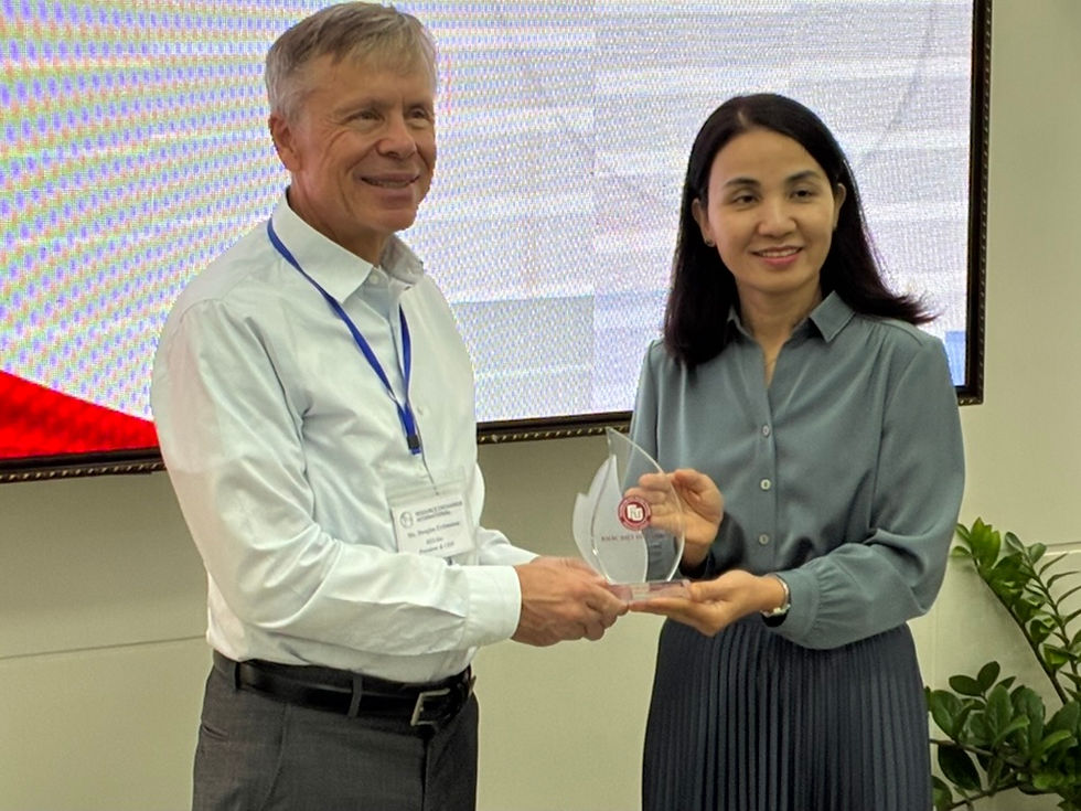 REI President and CEO, Doug Erdmann, receiving a gift from Dr. Nguyen, vice rector of the Foreign Trade University 2 in Ho Chi Minh City, Vietnam