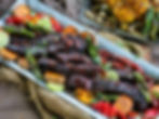 A platter of festive pork riblets with peppers and sweet potatoes.
