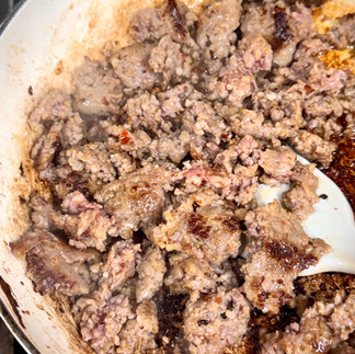 Brown Italian sausage and transfer to plate.