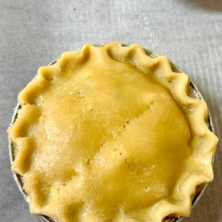 Brush egg wash on the top layer of pie dough for a golden finish.