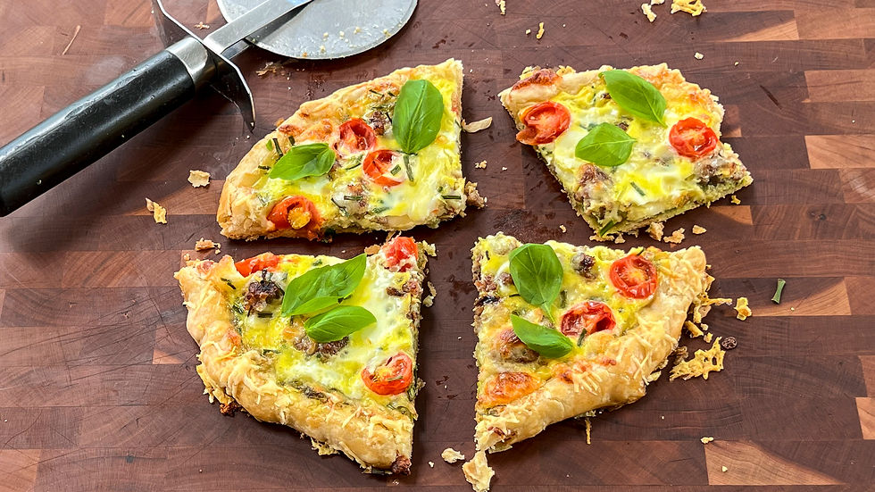 4 slices of breakfast pizza are on a serving board with a pizza wheel.