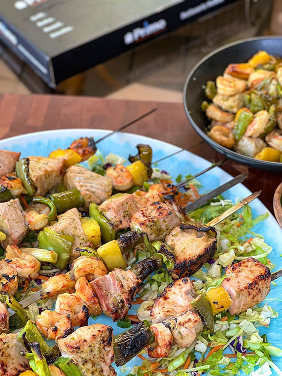 Summertime Sea Bass, Shrimp & Peach Rotisserie Kebabs on a blue platter.