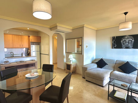 A warm living room features a soft sectional sofa, creating a harmonious ambiance.