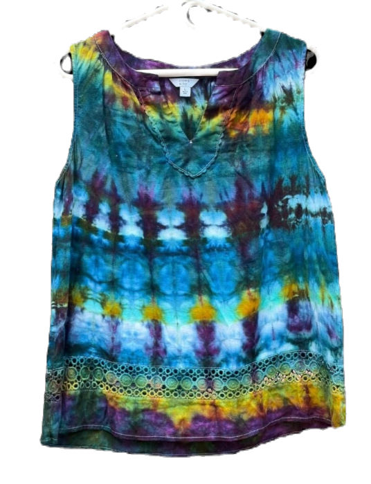 Blue and green spiral tie‑dye tank top modeled outdoors.
