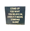 Black hand carved wood sign blacvk stained wit saying "stand up for what you believe in"