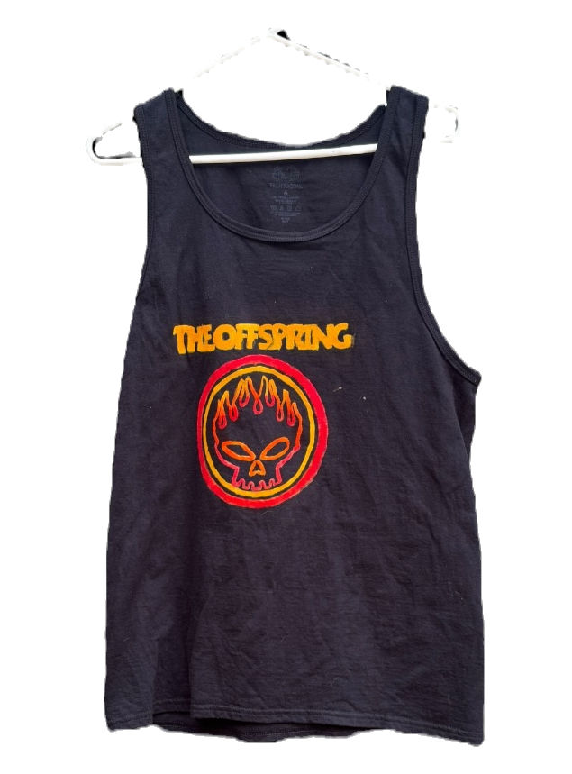 Black sleeveless tank with red and yellow circular graphic modeled indoors.