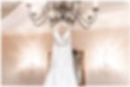 Bridal gown handing from chandelier Indian Springs South Jersey Wedding Country Club Marco's